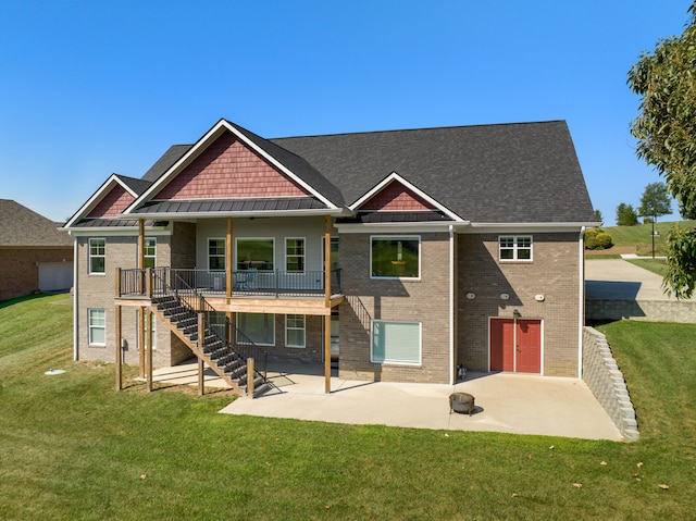 back of house featuring a garage, a yard, and a patio