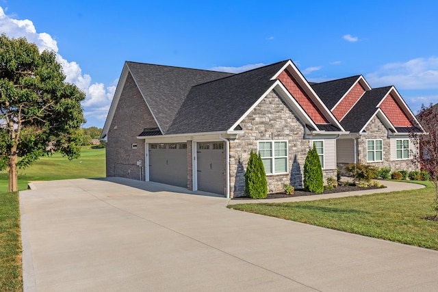 view of front of property featuring a front yard and a garage