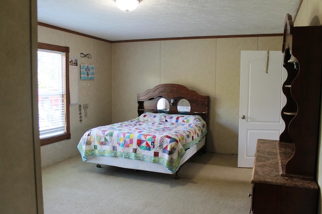 bedroom with a textured ceiling, ornamental molding, and carpet floors