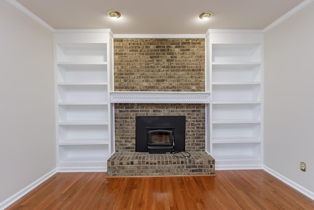 unfurnished living room featuring crown molding, hardwood / wood-style flooring, and built in features