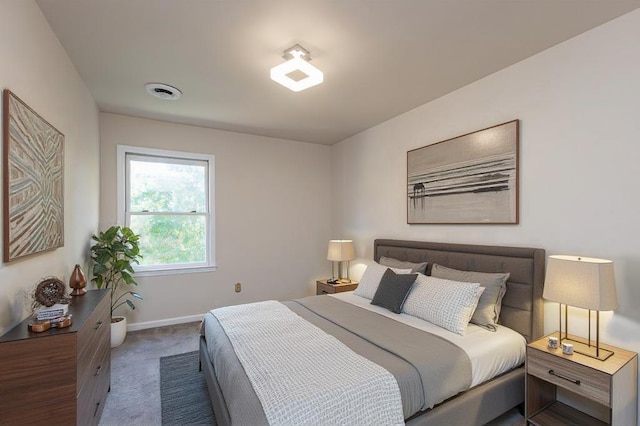 bedroom with dark colored carpet