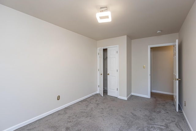 unfurnished bedroom with light carpet and a closet