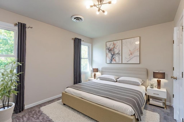 carpeted bedroom featuring a chandelier