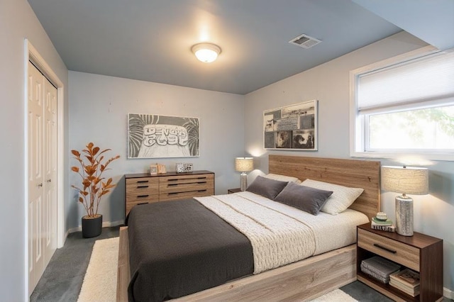 bedroom with dark carpet and a closet