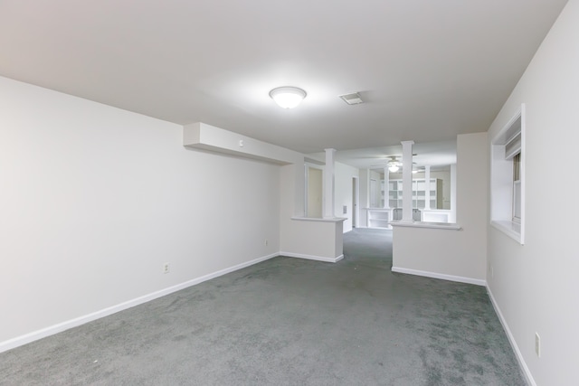 empty room featuring ceiling fan and dark colored carpet