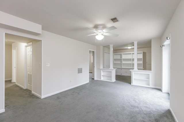 unfurnished living room with dark carpet, ceiling fan, and ornate columns