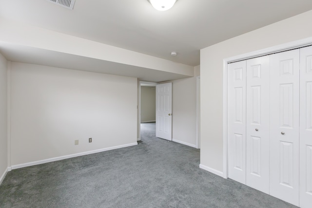 unfurnished bedroom with dark carpet and a closet