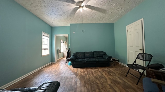 living room featuring a textured ceiling, hardwood / wood-style flooring, and ceiling fan