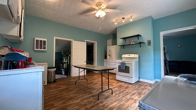 kitchen featuring a textured ceiling, ceiling fan, dark hardwood / wood-style floors, and white appliances