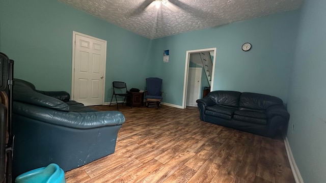 living room with hardwood / wood-style floors and a textured ceiling