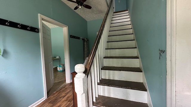 stairs with hardwood / wood-style floors, a textured ceiling, and ceiling fan