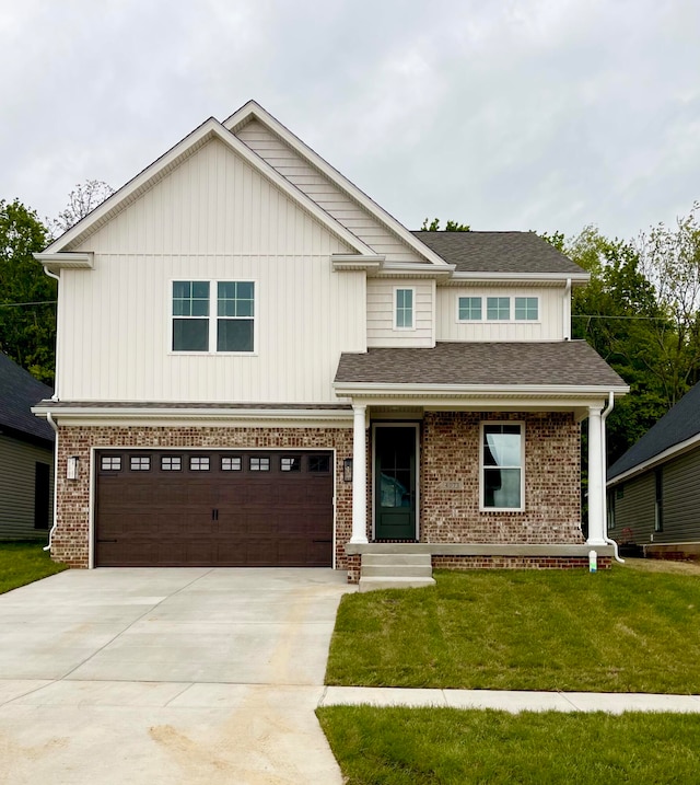 view of front of home featuring a front yard and a garage