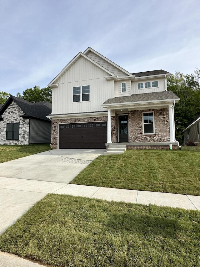 view of front of property with a front yard and a garage