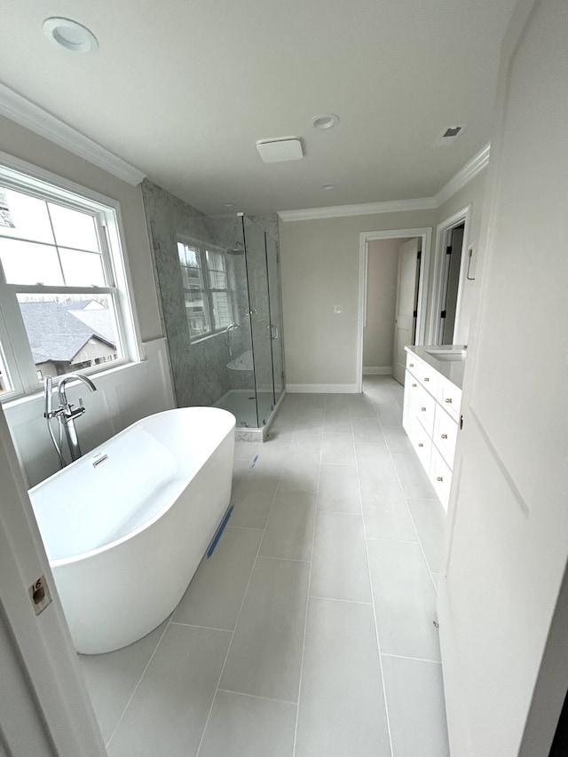 bathroom featuring a stall shower, ornamental molding, a freestanding bath, and tile patterned floors