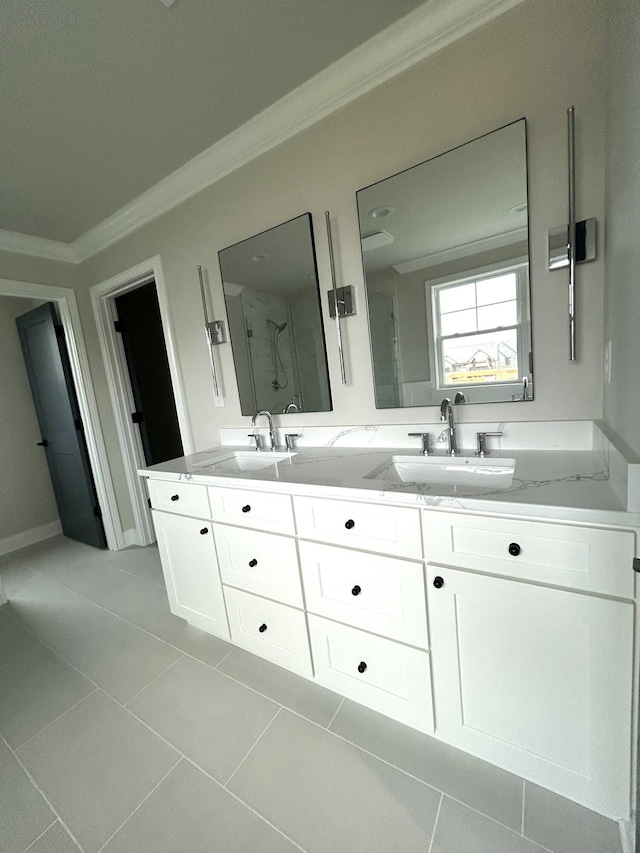 bathroom with crown molding, a sink, a marble finish shower, and double vanity