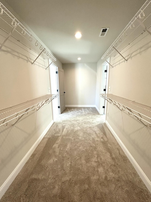 spacious closet with carpet flooring and visible vents