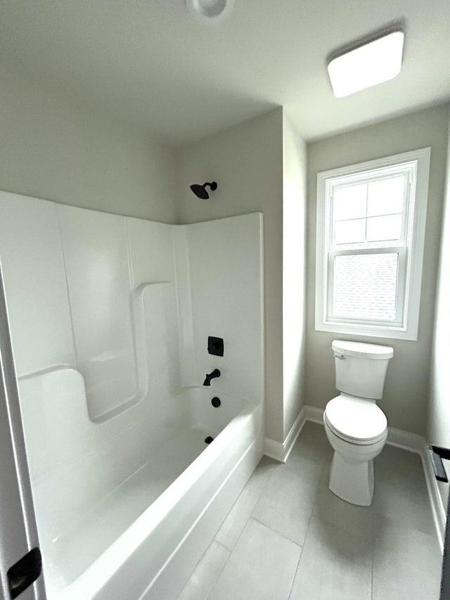 full bathroom featuring bathtub / shower combination, toilet, and baseboards