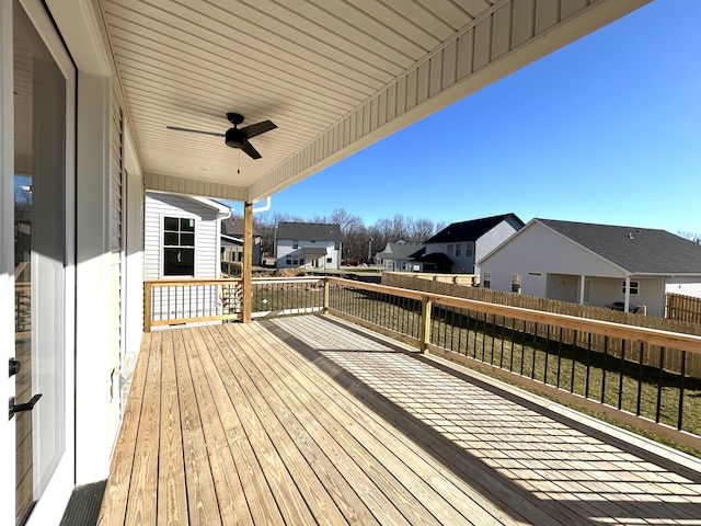 wooden terrace featuring a ceiling fan and a residential view