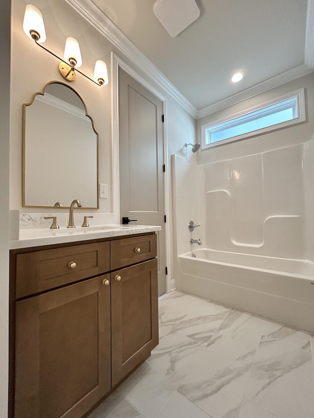 bathroom featuring marble finish floor, bathtub / shower combination, crown molding, and vanity