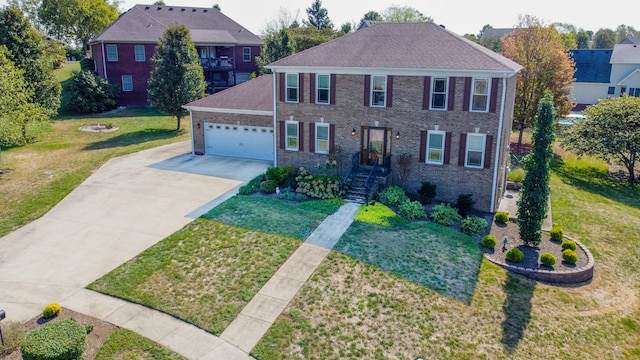 colonial home with a garage and a front lawn