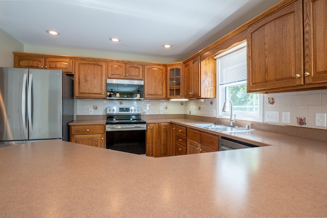 kitchen with backsplash, sink, and stainless steel appliances