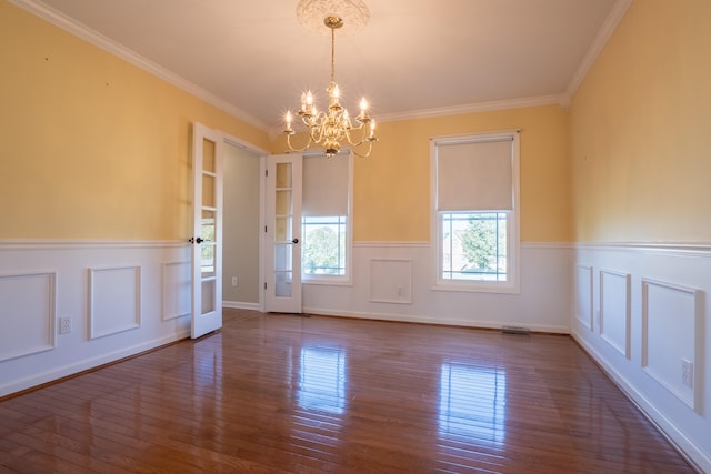 unfurnished room featuring wood-type flooring, ornamental molding, and a chandelier