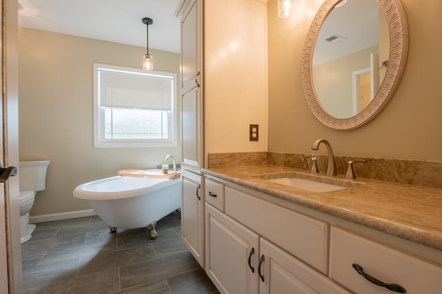 bathroom featuring a bath, vanity, and toilet