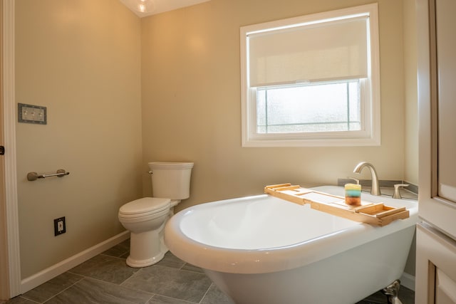 bathroom with a bathing tub and toilet