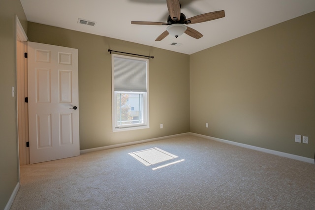 carpeted spare room with ceiling fan