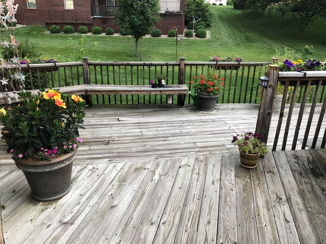 wooden terrace with a lawn