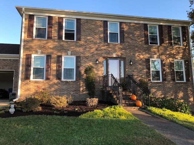 colonial-style house with a front lawn