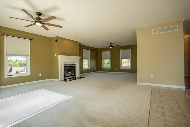 unfurnished living room with ceiling fan and light tile patterned flooring