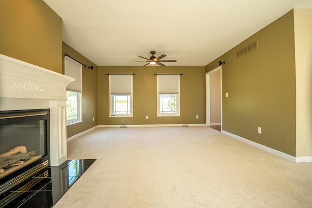 carpeted living room with ceiling fan