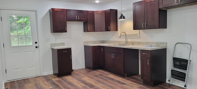 kitchen featuring dark hardwood / wood-style floors, sink, and pendant lighting