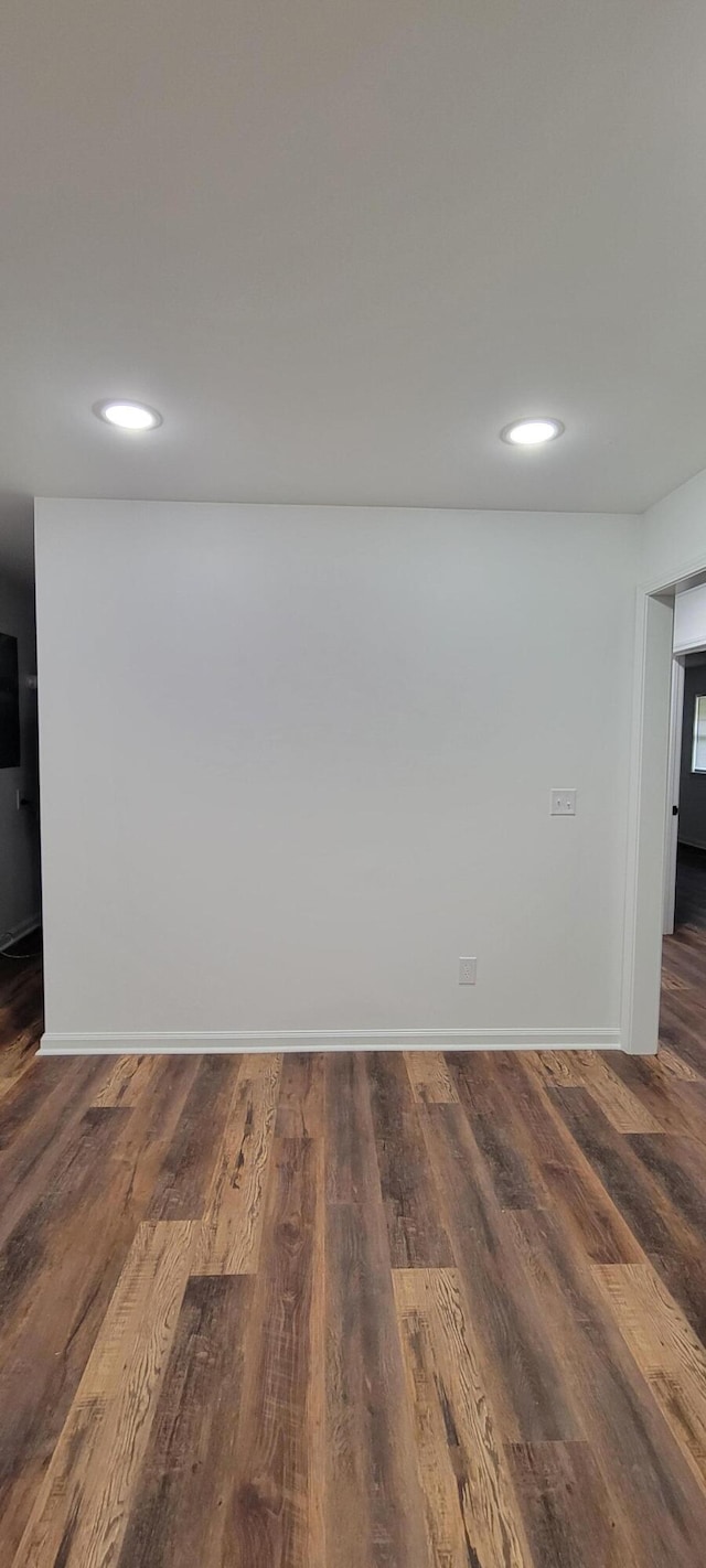 unfurnished room with dark hardwood / wood-style floors