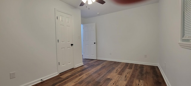 unfurnished room with dark hardwood / wood-style floors and ceiling fan