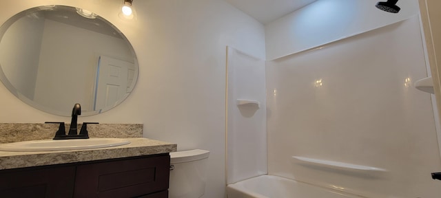 full bathroom featuring bathing tub / shower combination, vanity, and toilet