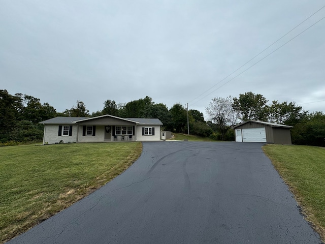 single story home with an outdoor structure, a garage, and a front lawn