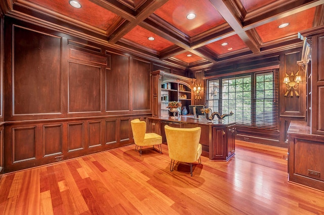 unfurnished office featuring beam ceiling, wooden walls, light hardwood / wood-style flooring, coffered ceiling, and crown molding