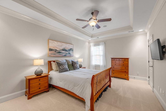 bedroom featuring a tray ceiling, ornamental molding, ceiling fan, and light colored carpet