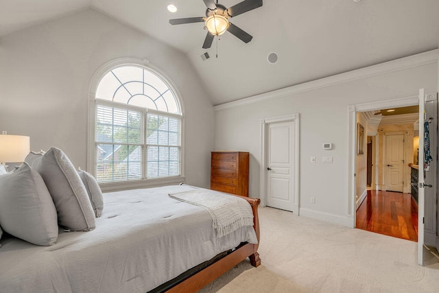 carpeted bedroom with crown molding, lofted ceiling, and ceiling fan