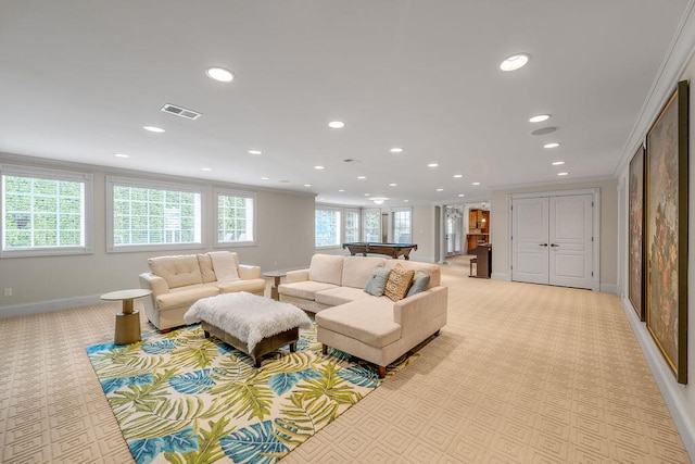 living room featuring ornamental molding and light colored carpet