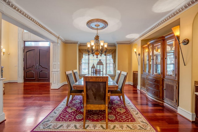 dining space featuring a notable chandelier, crown molding, and dark wood-type flooring