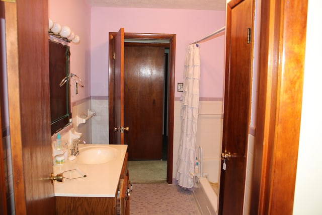 bathroom with shower / bath combination with curtain, vanity, and tile patterned floors