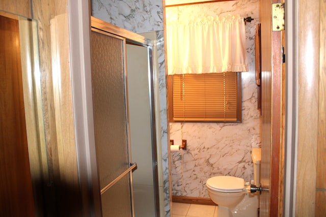 bathroom with tile patterned floors, toilet, and walk in shower