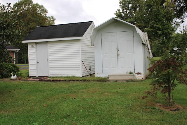 view of outbuilding with a yard