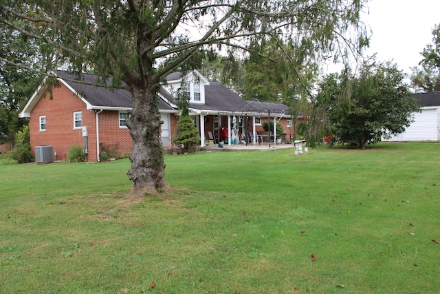 view of yard with a patio and central AC unit