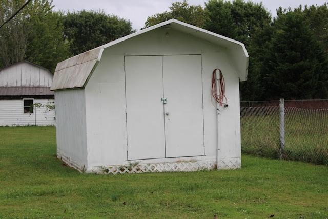 view of outbuilding with a lawn