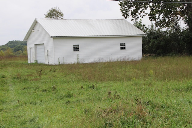 view of side of property with an outbuilding