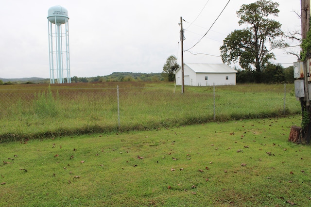 view of yard with a rural view